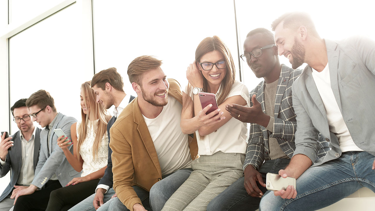 a group of friends one person is checking her phone